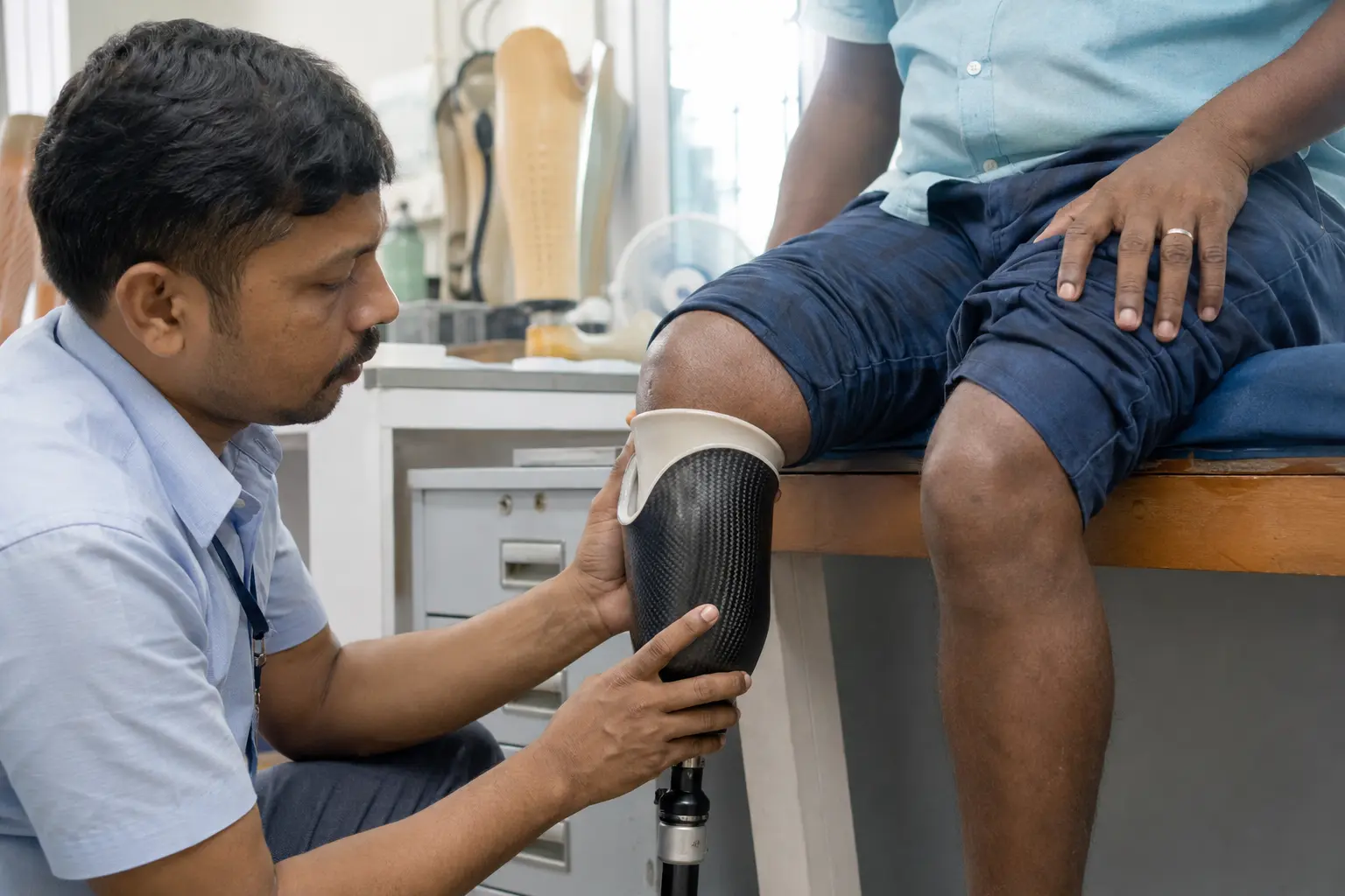 Clinician fitting a lower-limb prosthetic socket for a patient